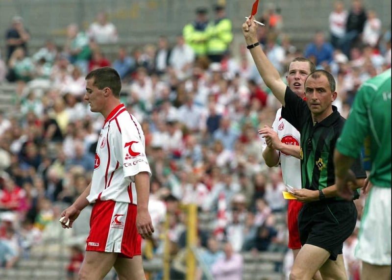 Ref Seamus McCormack shows Brian McGuigan of Tyrone the red card