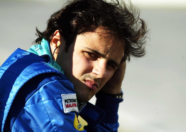 Ferrari's Felipe Massa held off his team-mate Michael Shumacher and world champion Fernando Alonso to take his first F1 win
