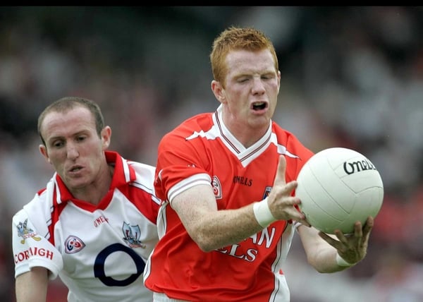 Armagh's Michael McNamee, scorer of 1-2, is pursued by Cork's Michael Prout