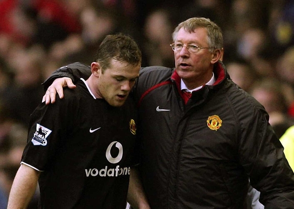 Wayne Rooney receives a comforting arm from United manager Alex Ferguson