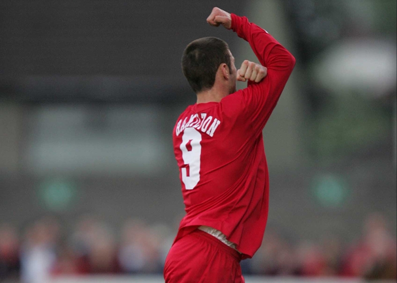 Gary Hamilton lets Cork fans know what he thinks of them as he walks off after his red card, having already scored the goal that secured Portadown victory