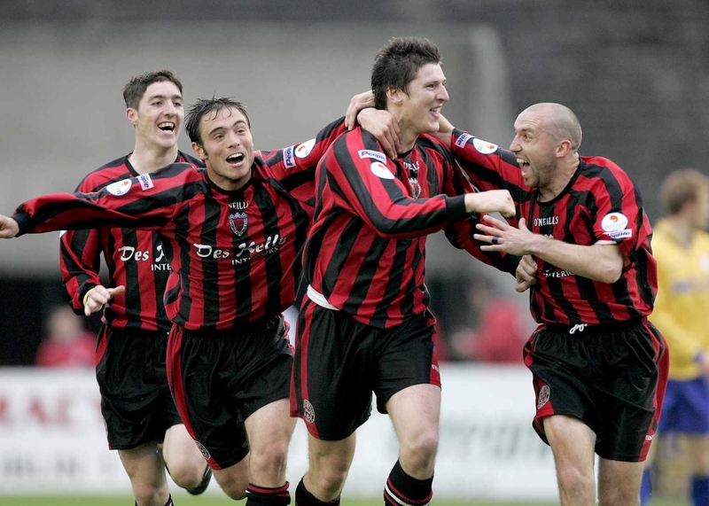 Ken Oman (second from left) celebrates with team-mates after scoring the winner against Shelbourne