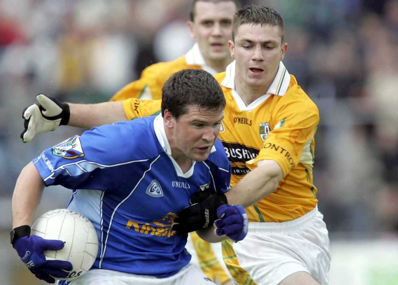 Antrim's Tony Scullion tries to tackle Larry Reilly of Cavan