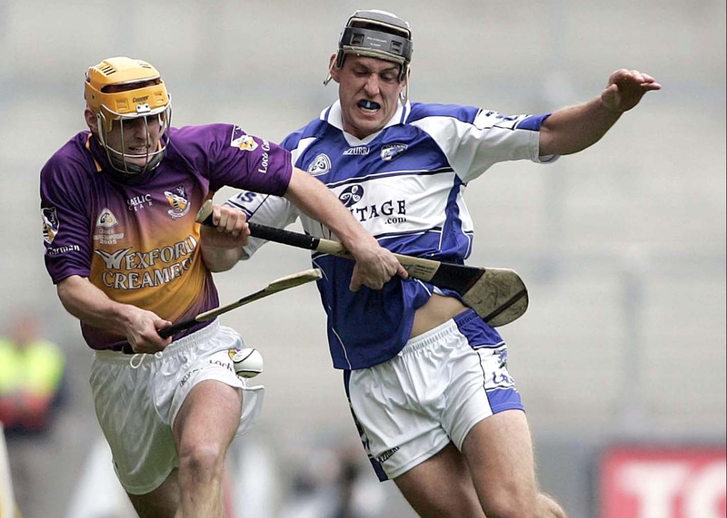 Wexford's Eoin Quigley and Darren Rooney of Laois tussle