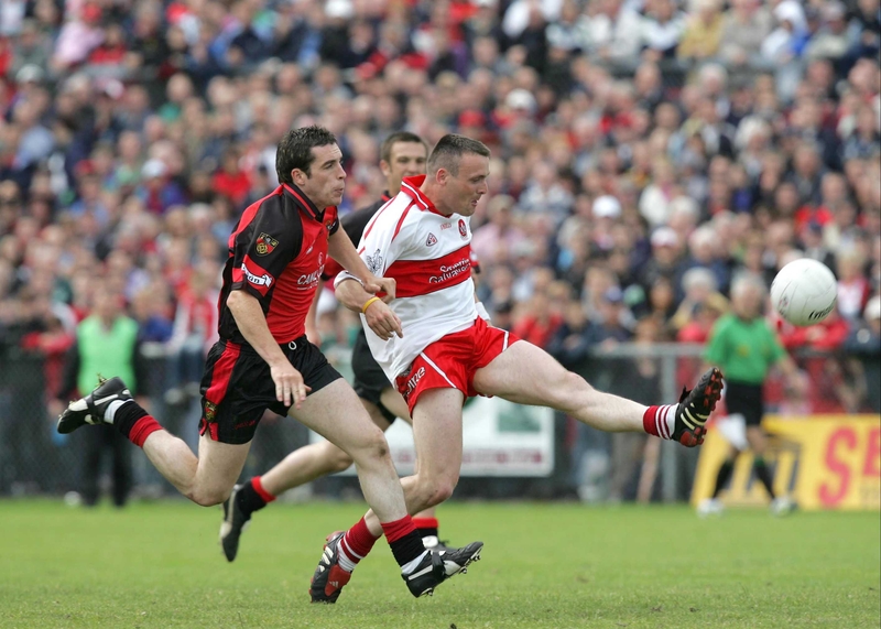Paddy Bradley of Derry tussles with Brendan Grant of Down