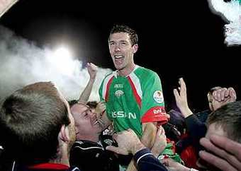 Cork City midfielder George O'Callaghan is held aloft by jubilant fans