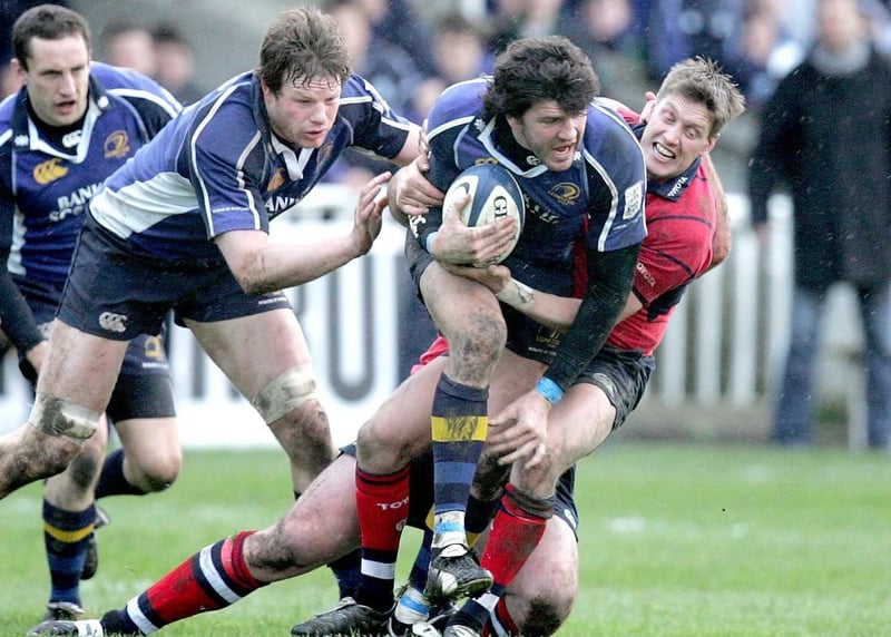 Ronan O'Gara takes on Shane Horgan and Malcolm O'Kelly during the match at the RDS