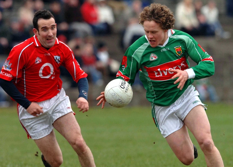 Andy Moran of Mayo is chased by Cork's Keiran O'Connor