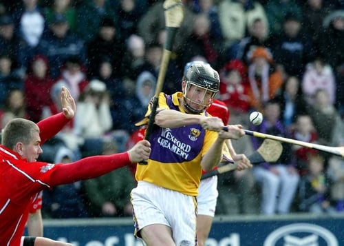 MJ Furlong is tackled by Diarmaid O'Sullivan of Cork
