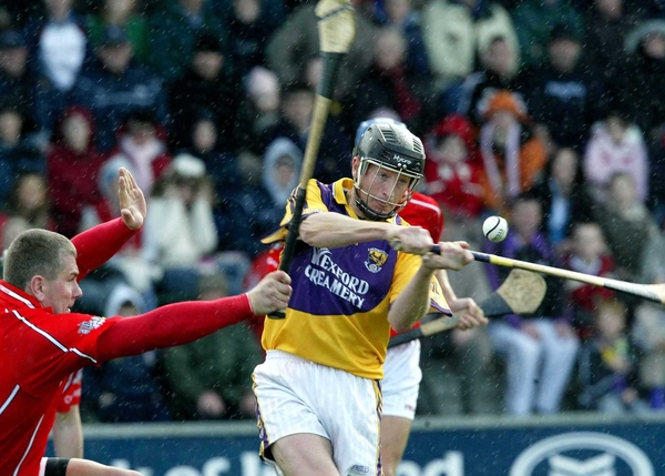 MJ Furlong is tackled by Diarmaid O'Sullivan of Cork
