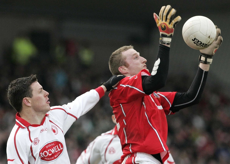 Nicholas Murphy of Cork is tackled by Tyrone's Conor Gormley