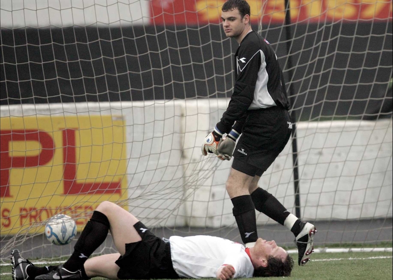 Dundalk's David Hoey lies on the ground after scoring an own goal watched by his 'keeper Chris Bennion