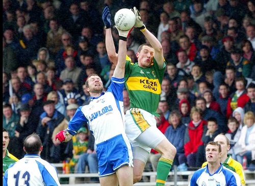 Keiran Donaghy of Kerry and Waterford's Aiden Ahearne challenge each other for the ball