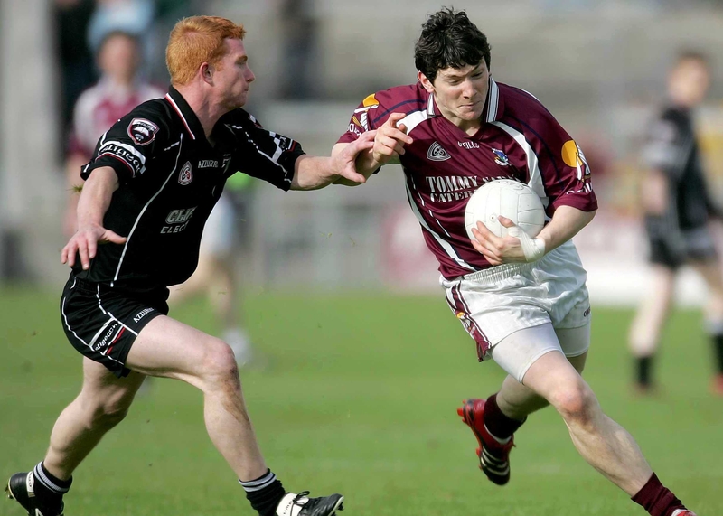 Galway's Micheal Meehan powers past Ross Donavon of Sligo