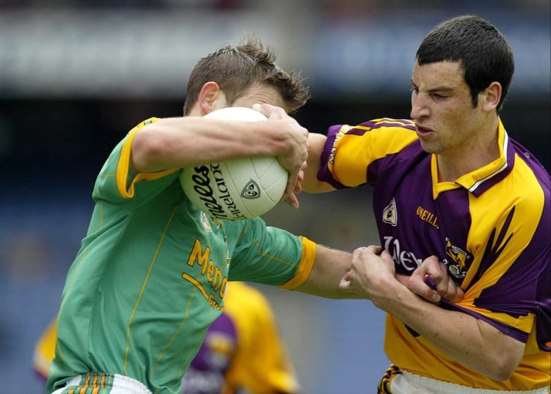 Brian Farrell of Meath is held by Wexford's Graeme Molloy
