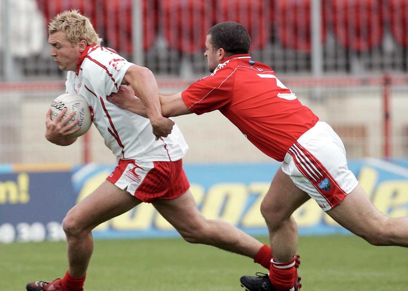 Owen Mulligan goes past Colin Goss of Louth
