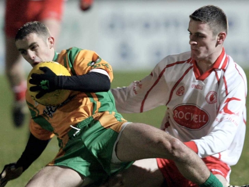 Damien McCaul (right) tackles Donegal's Kevin McMenamin last Saturday