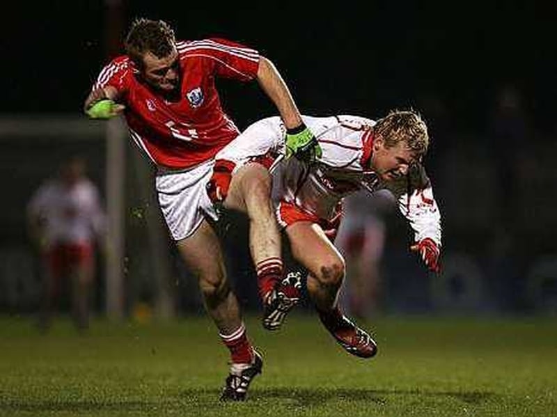 Cork's Ger Spillane and Tyrone's Owen Mulligan get up close and personal