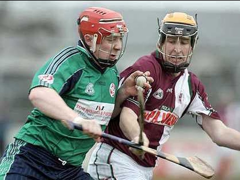 LIT's Joe Canning (l) takes on Martin Ryan of NUIG (r)