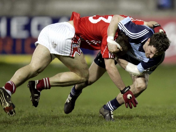 Dublin's Kevin Bonner and Michael Shields of Cork tussle for posession