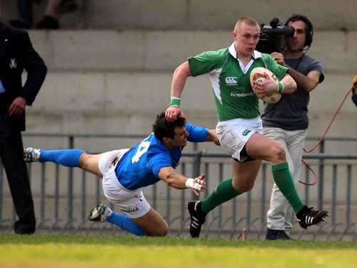 Ireland's Keith Earls rounds Michele Sepe during today's match at Stadio Stada Colomba