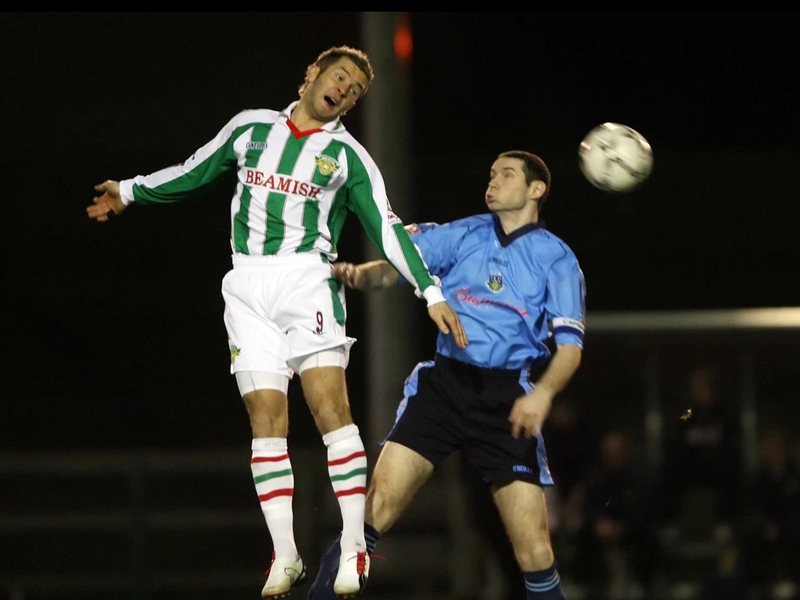 Alan McAnally (UCD) and John O'Flynn (Cork City) compete for the ball