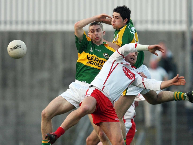 Marc O'Se and Bryan Sheehan of Kerry tussle for possession with Owen Mulligan
