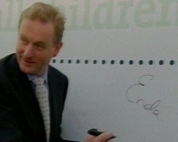 Enda Kenny - Signs 'contract'