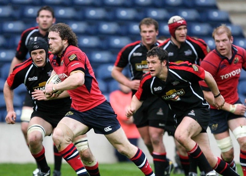 John O'Sullivan of Munster breaks from Simon Taylor and Alan MacDonald of Edinburgh