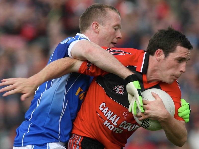 Down's Brendan Grant holds off Cavan's Jason O'Reilly at Kingspan Breffni Park today
