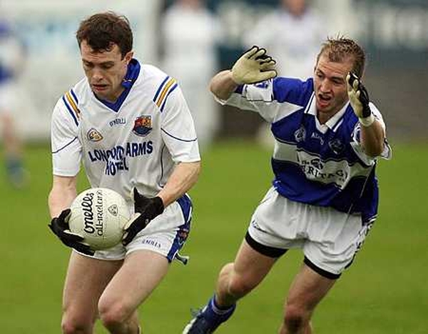 Longford's David Barden is closed down by Joe Higgins of Laois