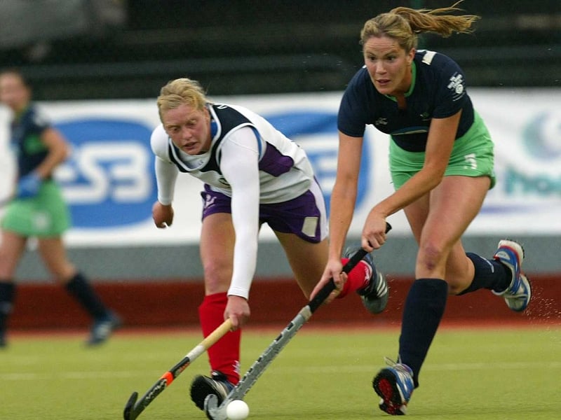Louise Munn of Scotland and Ireland's Linda Caulfield battle for possession at the National Hockey Stadium