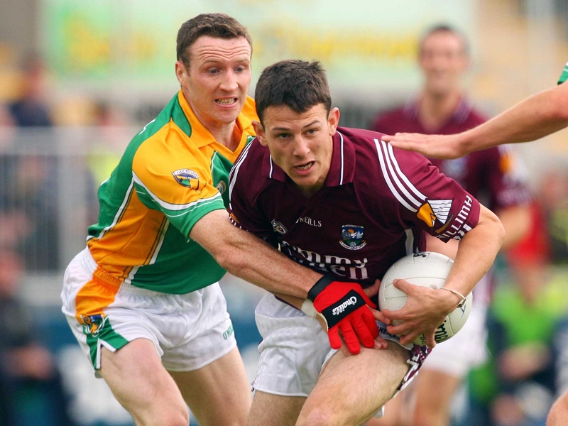 Galway's Sean Armstrong tries to escape the clutches of Leitrim's Dermot Reynolds