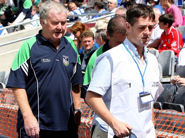 Limerick manager Richie Bennis is escorted to the stand by a GAA official