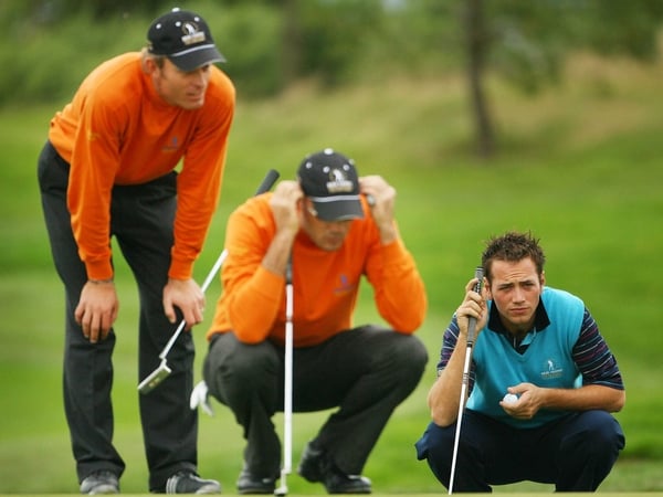 Nick Dougherty examines the line of his putt as Raphael Jacquelin and Gregory Havret do likewise