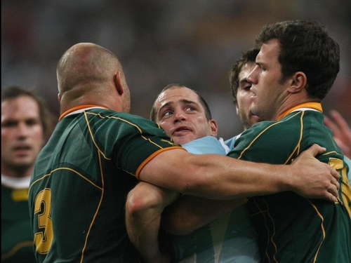 Felipe Contepomi struggles with two Springboks as the match ebbs away from Argentina