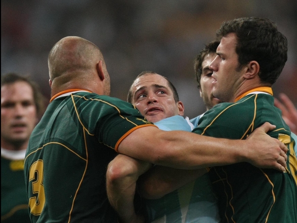Felipe Contepomi struggles with two Springboks as the match ebbs away from Argentina
