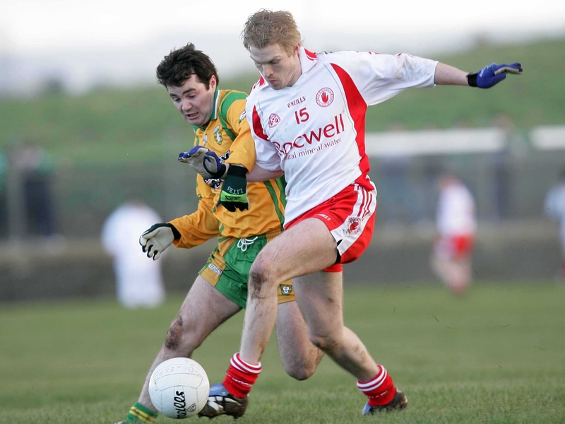 Tyrone's Sean O'Neill &amp; Niall McCready of Donegal tussle for possesion