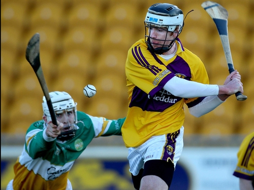 John Breen of Wexford is challenged by Offaly's Kevin Brady