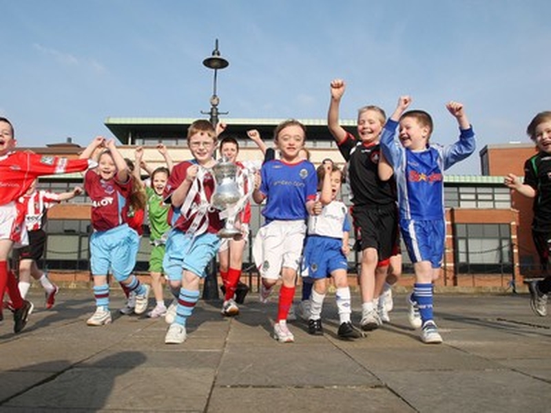 Children sporting kits from all eight teams mark the launch of the competition