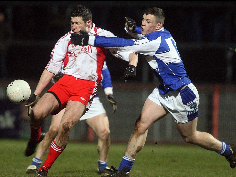 Sean Cavanagh shoots for a score under pressure from John O'Loughlin