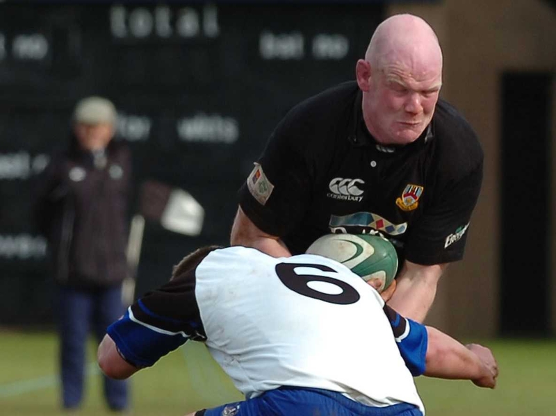 Ballymena's Darren Best is tackled by Frank Cogan of Cork Con