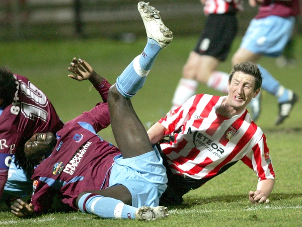Derry's Clive Delaney and Ibrakima Thiam of Drogheda take a tumble