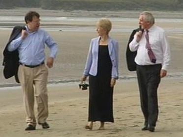 Known for his walks on the beach, Ahern walks with Brian Cowen and Mary Hanafin in Cork