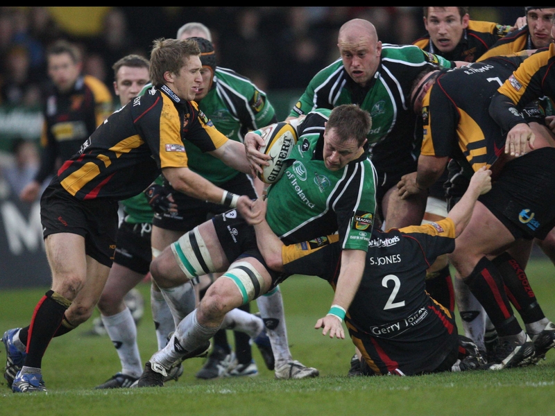Connacht's Colm Rigney is held by Dragons' Steve Jones