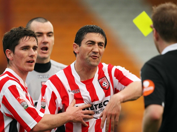 Peter Hutton is booked for remonstrating with Alan Kelly after the penalty was awarded at Tolka Park