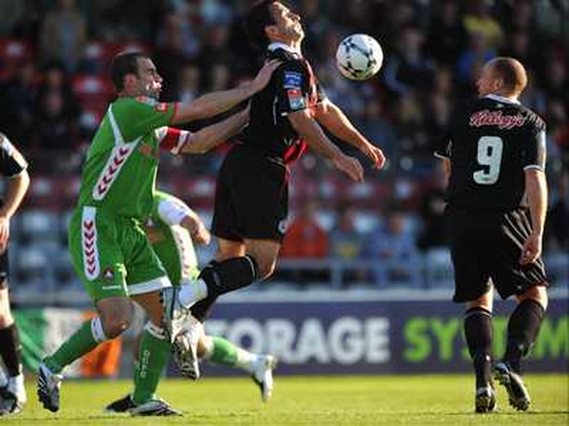 Neale Fenn of Bohemians controls the ball with Dan Murray of Cork City in close attention