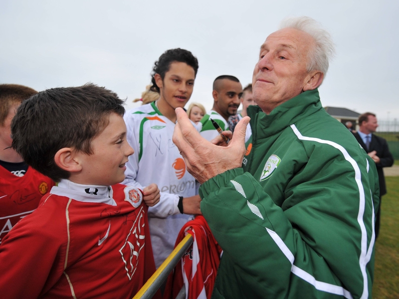 Giovanni Trapattoni shares a joke with a young fan at the end of a training session in Malahide