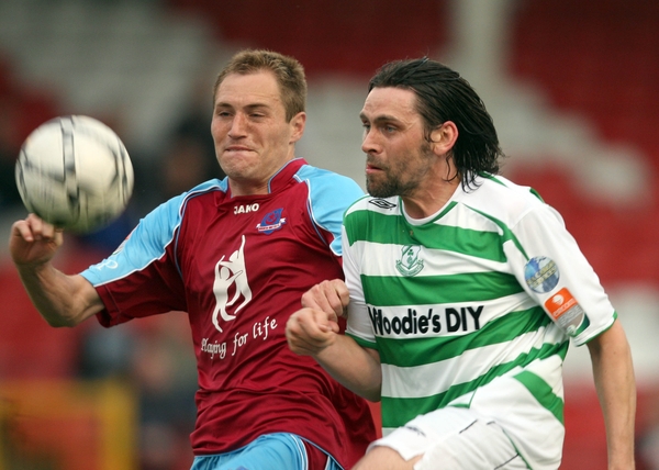 Adam Hughes of Drogheda and Rovers' Darragh Maguire tussle for ball