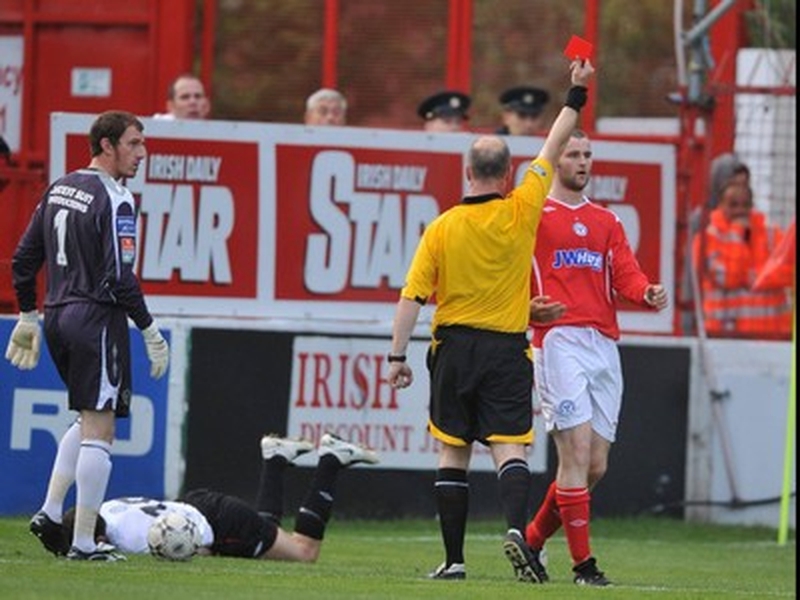 Shelbourne's Alan Keely recieves a red card from referee Tomas Connolly.